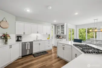 Bright & Functional Chef’s Kitchen - crisp white cabinetry, full-height backsplash, and under-cabinet lighting give this kitchen a clean, upscale feel. Enjoy ample storage, updated fixtures, and lush views from the adjacent breakfast nook.
