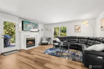 Bright Family Living with Backyard Access - enjoy seamless indoor-outdoor living in this welcoming family room with direct access to the backyard deck. Anchored by a cozy fireplace, this space blends functionality and warmth for everyday living.