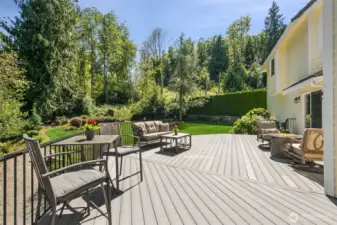 Entertainer’s Dream Deck Overlooking Lush Greenbelt. Expansive composite (TREX) deck offers multiple seating areas, perfect for outdoor dining, relaxing by the fire pit, or hosting summer gatherings—all surrounded by mature trees and serene privacy.