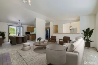 GRACEFUL LIVING ROOM WITH EASY ACCESS TO KITCHEN AND DINING AREA.