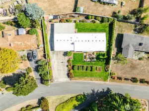 Mature landscaping, raised garden bed, raised flower beds, rain barrel and flag pole