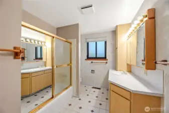 HALL BATH  Spacious layout  Full tub/shower with sliding door  Single vanity with mirrored medicine cabinet  Vinyl tile floor/ Cabinet above toilet
