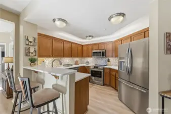 The updated kitchen is truly a Chef’s Kiss with new quartz counters, custom backsplash, under    cabinet lighting and newer stainless-steel appliances.