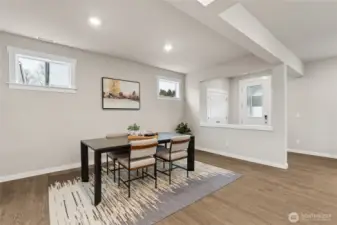 Spacious Dining room with transom windows to let natural light in.  Materials, colors, and finishes will vary. See site agent for details