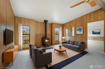 This is the virtually staged family room with a toasty woodstove and lots of natural light.
