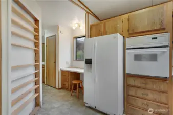 The hall goes to the built in desk and utility room.