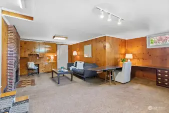 Lower level family room is spacious and cozy with vintage wood paneling.