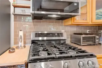 Kitchen upgrades include new SS appliances and glass tile back splash.