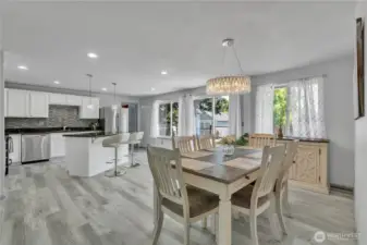 Open concept living room and kitchen with sliding door to back deck