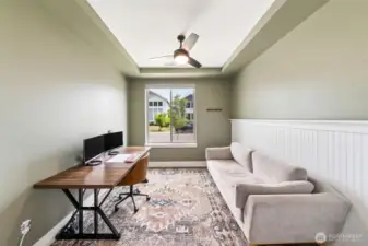 Den with custom features and French doors
