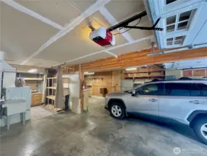 Space for 2-3 cars, and laundry area with shelving