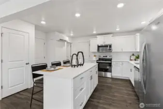 “Modern kitchen featuring quartz countertops and stainless steel appliances.”