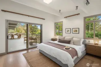 The main floor primary suite opens to the deck with beautiful garden views and sits adjacent to the library.