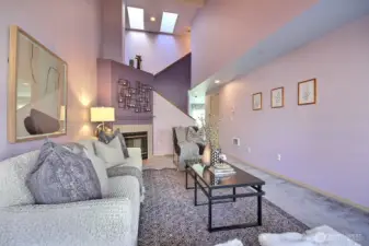 This generously sized living space offers a versatile layout for your largest sectionals and statement furniture, all framed by elegant high-sloped ceilings.