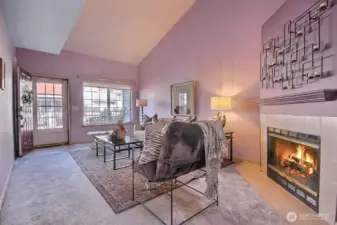 Large windows flank the living room, inviting an abundance of natural light throughout the day.  Enjoy the cozy wood-burning fireplace on those chilly days.