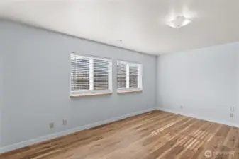 Primary bedroom lets in great natural lighting and new flooring