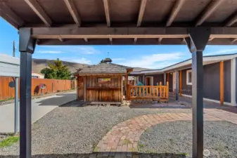 Porch from outbuilding, looking over the driveway and graveled back yard space