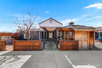 paved driveway and covered entry to the back door of the home