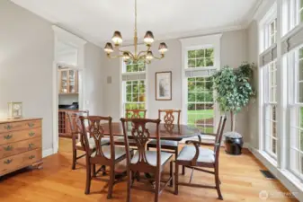 Formal dining room off foyer. Floor to ceiling double sashed wood windows throughout.