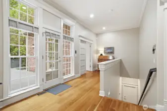 The millwork alone is a work of art with wood wrapped hallway entries, solid core doors with transom windows, tall baseboards and floor to ceiling double sashed Pella wood windows