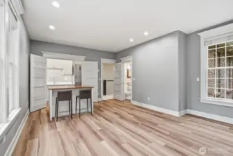 Behind double doors is a hidden kitchenette with full size refrigerator and dishwasher; this area makes a great guest or MIL area.