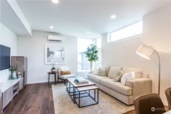 Large living room has ample space for a sectional, chairs, and entertainment center.  This picture does not do that space justice!