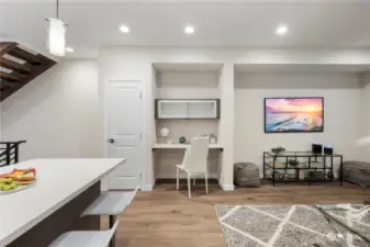 Photo of previous model Avenue plan (there is 1 more of this plan left in this phase). Large living room has ample space for a sectional, chairs, and entertainment center.  Work from home space (or bar setup) and pantry closet included.  You are welcome!