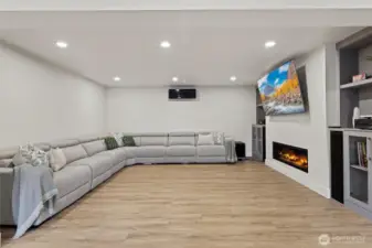 Giant media room with HeatGlo fireplace & TV with integrated high-end sound system