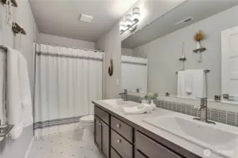 Hall bath - double vanity, with a tub/shower combo.