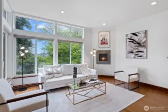 Open concept living room features a floating fireplace