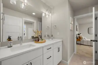 Full bathroom on upper level with double sinks.