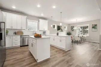 Chef's kitchen with breakfast bar and prep island & dining area