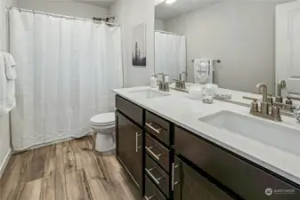 The guest bath has quartz counters and a full tub/shower combo.