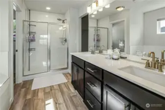 The ensuite primary bath boasts gorgeous finishes, a double sink vanity, separate shower and soaking tub. The huge walk-in closet is just through the doorway....