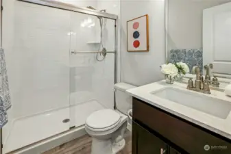 ADU bathroom with quartz counters and walk-in shower.