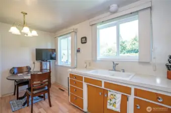 Dining area with a lovely window overlooking the lush, private backyard.