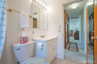A second view of the full bathroom reveals the hallway that connects seamlessly to the living area.