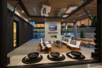 Outdoor covered living area with fireplace & BBQ