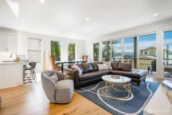 Open concept floor plan between the kitchen, dining, living and main flloor deck.