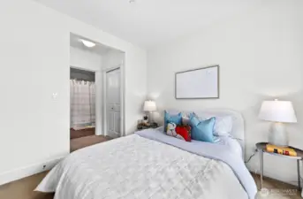 The bedroom has two closets and access to the full bathroom.