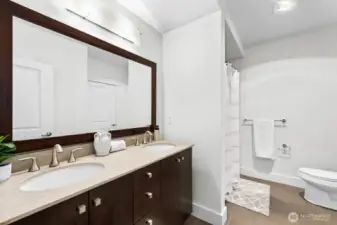 Spacious full bathroom with dual vanity sinks. The bathroom has access from both the bedroom and the main living area.
