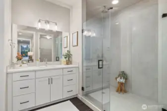 Luxurious bathroom in Owner's Suite with double vanity and walk-in shower.