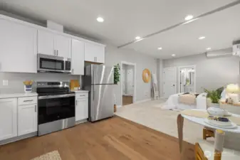 Lower level studio suite/ADU with full kitchen, full bath, and private entrance.