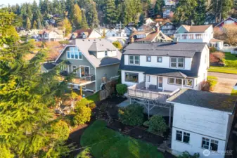 Back of home featuring unique two-story garage/storage building
