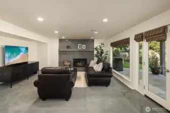 Downstairs, a garden-level bonus room with a cozy fireplace invites slower evenings.