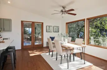 The dining area leads to the deck through the French doors.