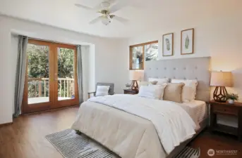 Primary bedroom has French Doors that lead to the front deck.
