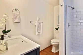 The bathroom is fully updated with new shower and vanity.