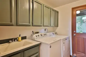 Laundry room on the main hall.  There is a utility sink and the door leads out to the back yard.
