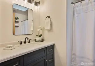 The hall bath is a full bath.  The vanity, lighting and mirror are new.